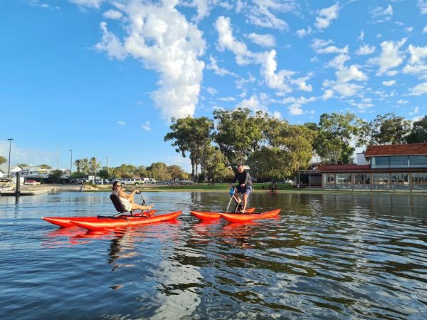 couple enjoying riding waterbikes on matilda bay