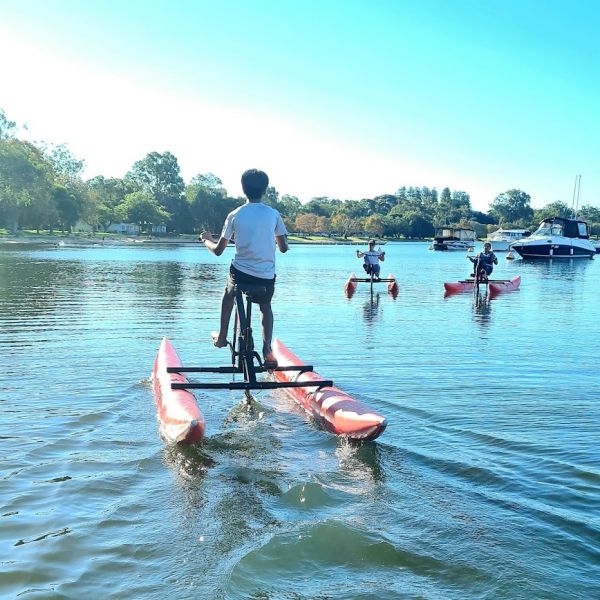 three people enjoying waterbike hire on the swan river in perth