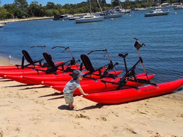 toddler with waterbikes on matilda bay foreshore.